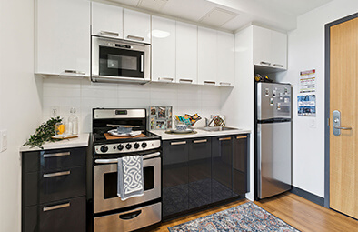 Furnished Centennial Residence bedroom suite with a twin bed and desk.